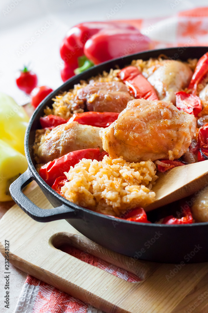 Chicken thighs and legs baked over a bed of rice and red bell pepper Chicken thighs and legs baked over a bed of rice and red bell pepper
