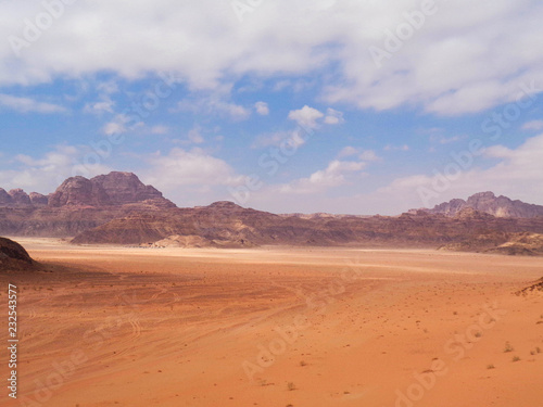 a rock in a red sand dessert