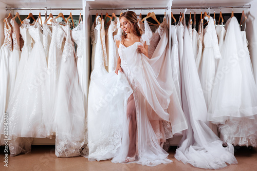 Female trying on wedding dress in a shop