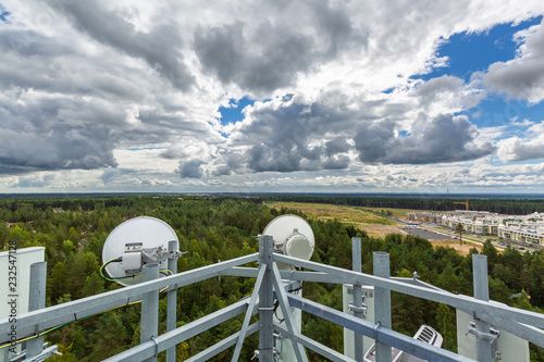 Telecommunication tower with microwave, radio antennas, remote radio units, power and optic cables
