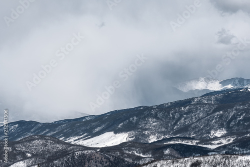 Mist rises as dramatic snowstorm moves across mountain valley © Tabor Chichakly