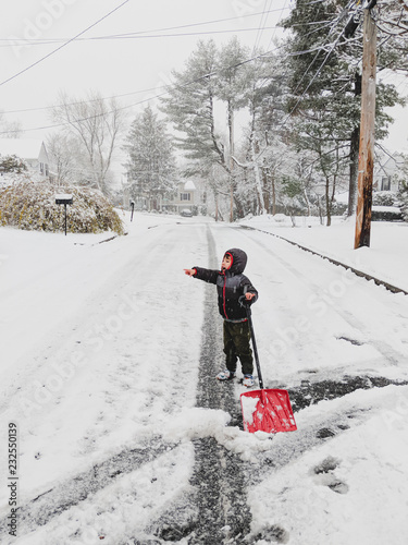 Little kid shoveling snow
