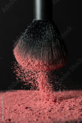 Close up of brush splashing pink face powder