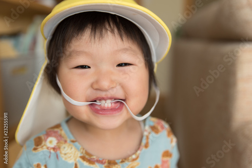 Children of 1 year old smile with rubber strings laughing