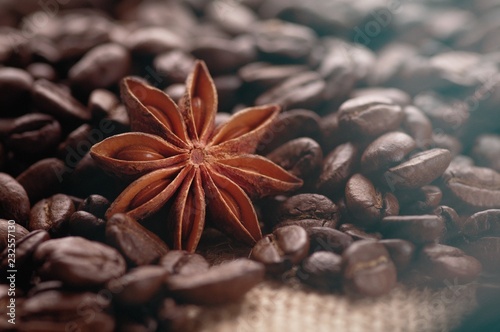 Aromatic roasted coffee beans and anis or badian background close up