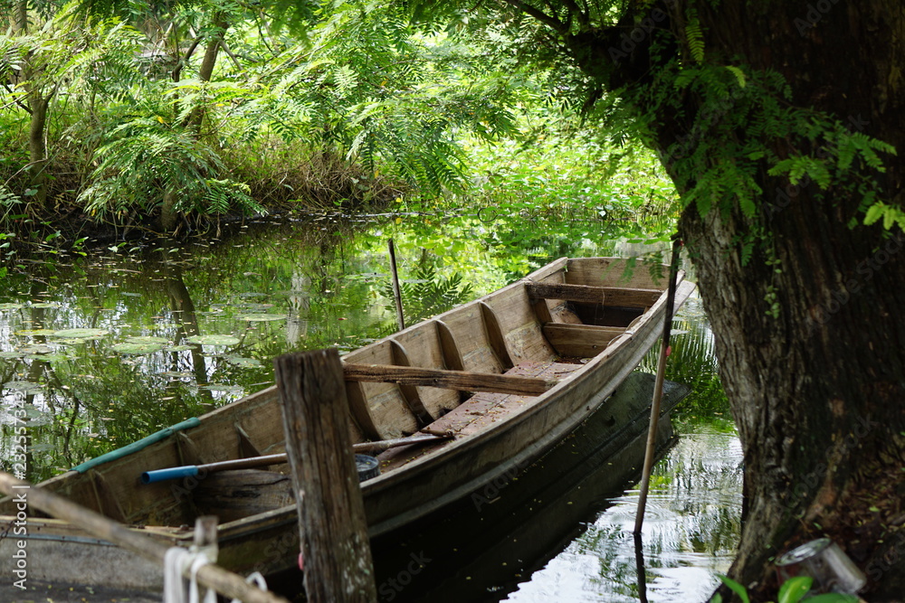 Old wooden boat floating in a canal. Old wooden boat floating in a canal.
