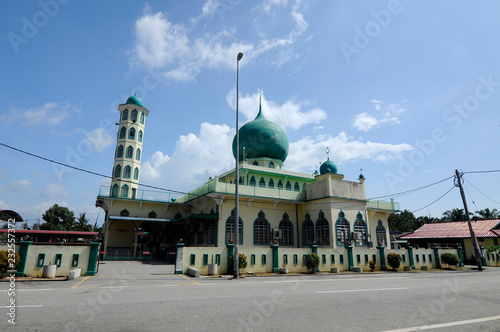 Exterior of Al-Athar Mosque in Bagan Serai, Perak, Malaysia. An old mosque was build in 1966. Has big green dome one tall minaret.  photo