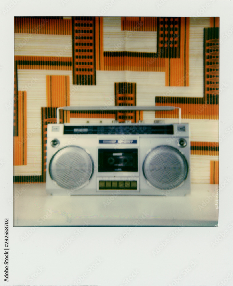 Polaroid scan of a ghetto blaster in front of 1980s fabric. Polaroid scan of a ghetto blaster in front of 1980s fabric.