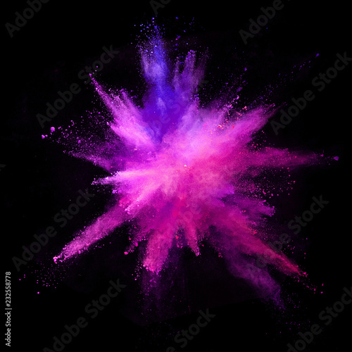 Explosion of coloured powder isolated on black background.