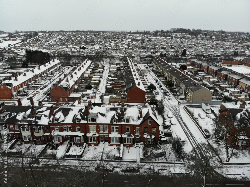 Aerial photo over looking fields and houses in the Snow, taken in Leeds West Yorkshire UK