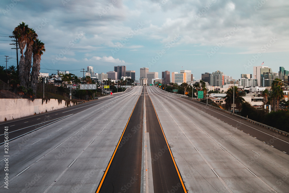 Empty San Diego Freeway with Sunset Sky - Horizontal, Horizontal landscape view of San Diego, California, USA Skyline with empty freeway in foreground. The 5 freeway