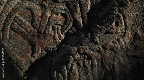 Tilt up on Jesus on Jelling stone, Denmark
