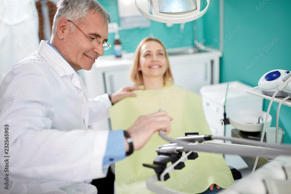 Fototapeta premium Male dentist with patient in dental practice
