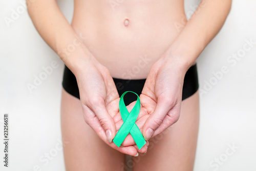Woman Wearing Underwear With Teal Ribbon Ovarian Cancer Awareness Woman healthy concept. © andrey_orlov