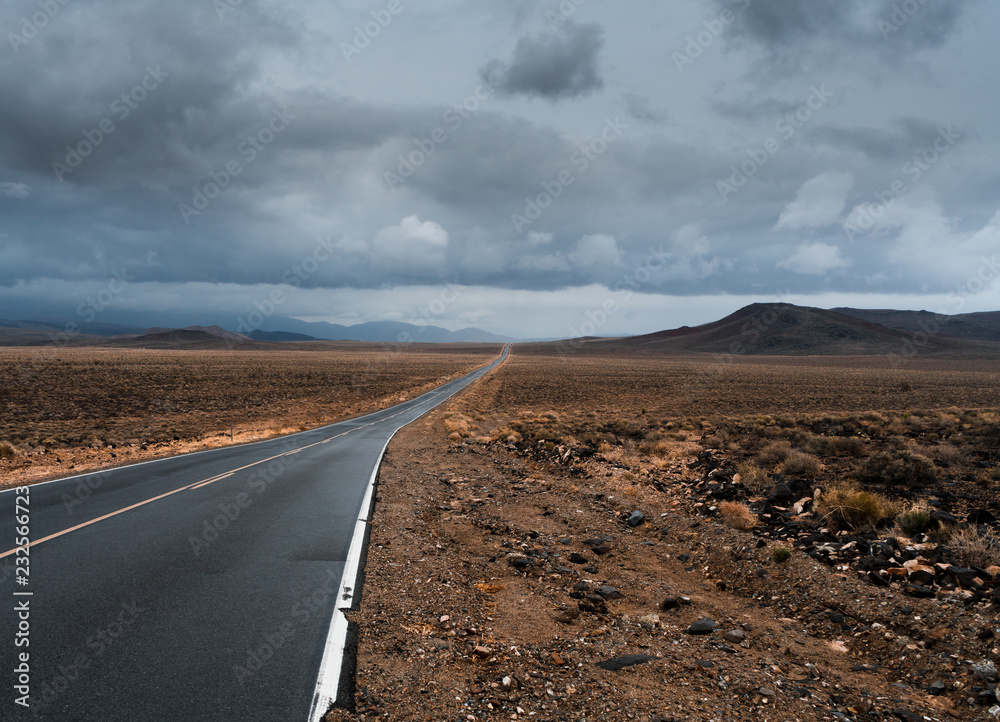 A road finds its way through Death Valley as a storm approaches