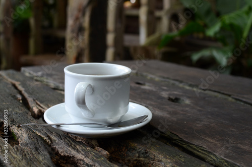 Cup Of Black Coffee on dead wood table