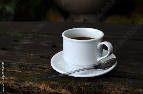 Cup Of Black Coffee on dead wood table