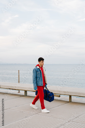 Man in red sportswear with bag