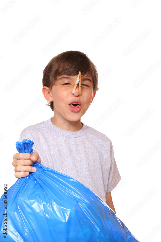 Kid with clothespin on his nose while holding a stinky garbage bag