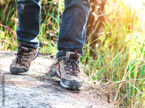 Close-up of male hiker shoes walking on a mountain trail.