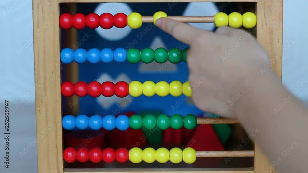 Child playing with wooden abacus Child playing with wooden abacus