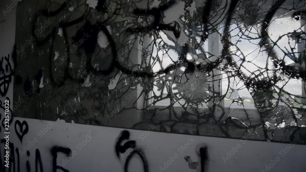 A pan of a broken mirror in a abandoned building