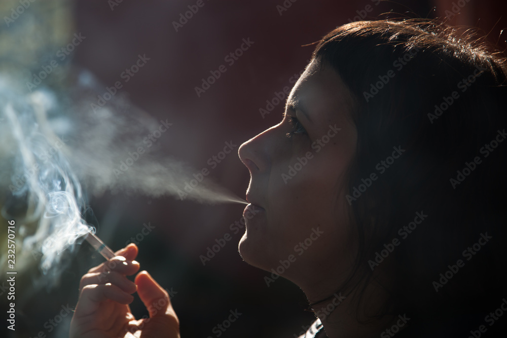 Fototapeta premium woman smoking a cigarette - anti smoking campaign