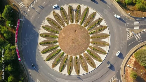 Aerial, screewdriver, drone shot, slowly turning, above cars driving in a roundabout or a traffic circle, in Estoril, Portugal photo