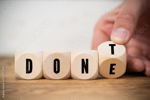 Hand turns two cubes, changing the word "don't" to "done" 