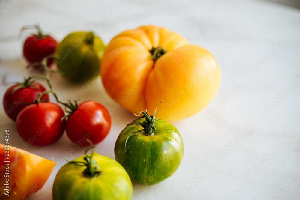 Fresh heirloom tomatoes on a kitchen table Fresh heirloom tomatoes on a kitchen table