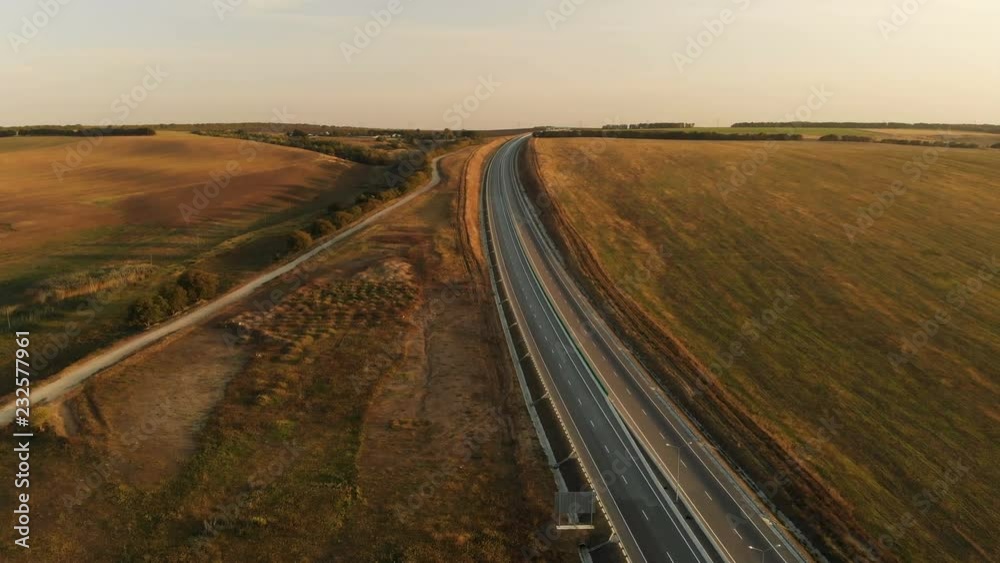 Aerial view. Highway and overpass with cars and trucks. The road junction is a two-tier road junction outside the city. View from above Aerial view. Highway and overpass with cars and trucks. The road junction is a two-tier road junction outside the city. View from above
