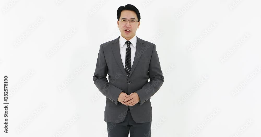 Handsome Asian businessman in suit standing on white background and talking something to camera then show turning his body in different angles. Handsome Asian businessman in suit standing on white background and talking something to camera then show turning his body in different angles.