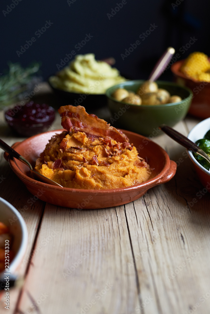 Turkey dinner and side dishes on a wood background. Turkey dinner and side dishes on a wood background.