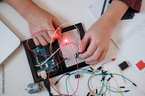 Boy working on an electronic DIY kit at home