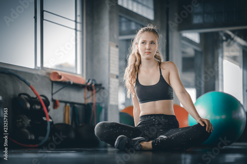 Portrait young attractive healthy woman body curve fitness doing exercises workout with ball in gym. People beauty perfect body slim fitness girl. Freedom happy and relax lifestyle healthcare concept