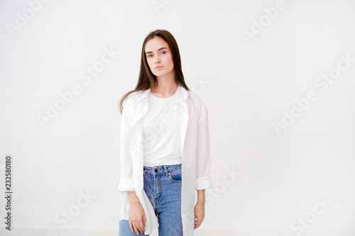 Young pretty woman wearing white shirt against white background