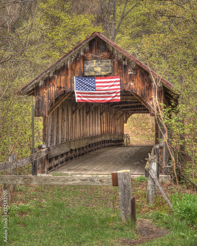 An abandoned covered bridge in the countryside photo