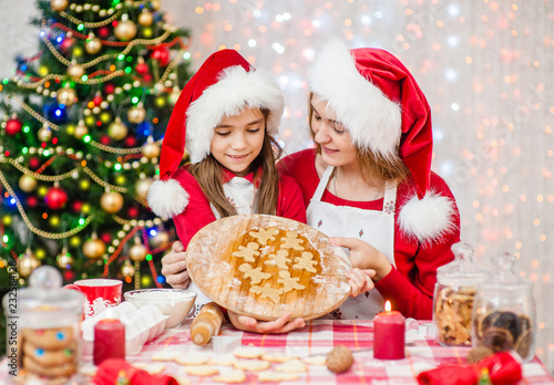Mother and daughter with Christmas cookies © Ermolaev Alexandr