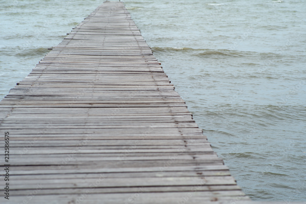 Fototapeta premium Abstract texture and background of wooden walkway into the sea