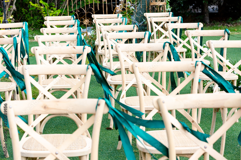 No one's outdoor wedding scene, green plants and neatly arranged chairs No one's outdoor wedding scene, green plants and neatly arranged chairs