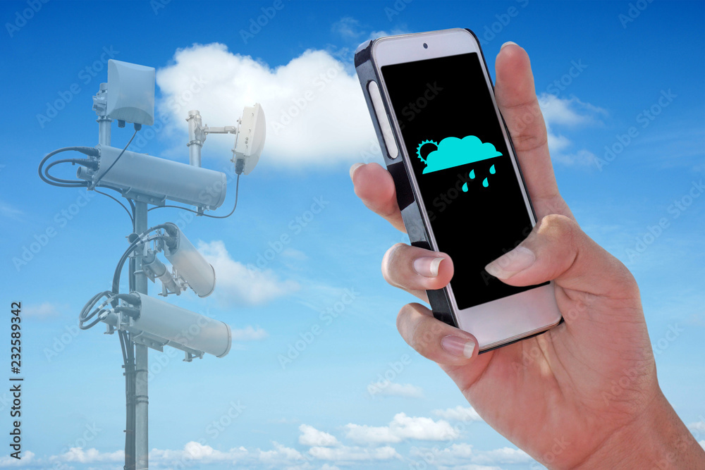 Cellular network antenna and Weather icon showing on the smartphone with blue sky. Cellular network antenna and Weather icon showing on the smartphone with blue sky.