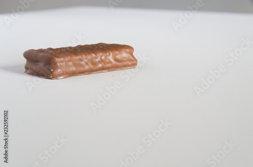 Chocolate biscuit on a white bench