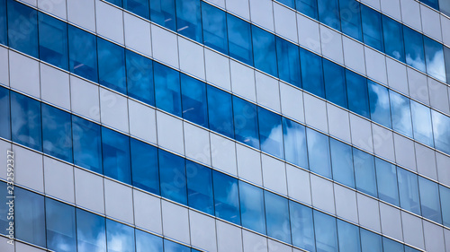 Modern glass building reflecting sky