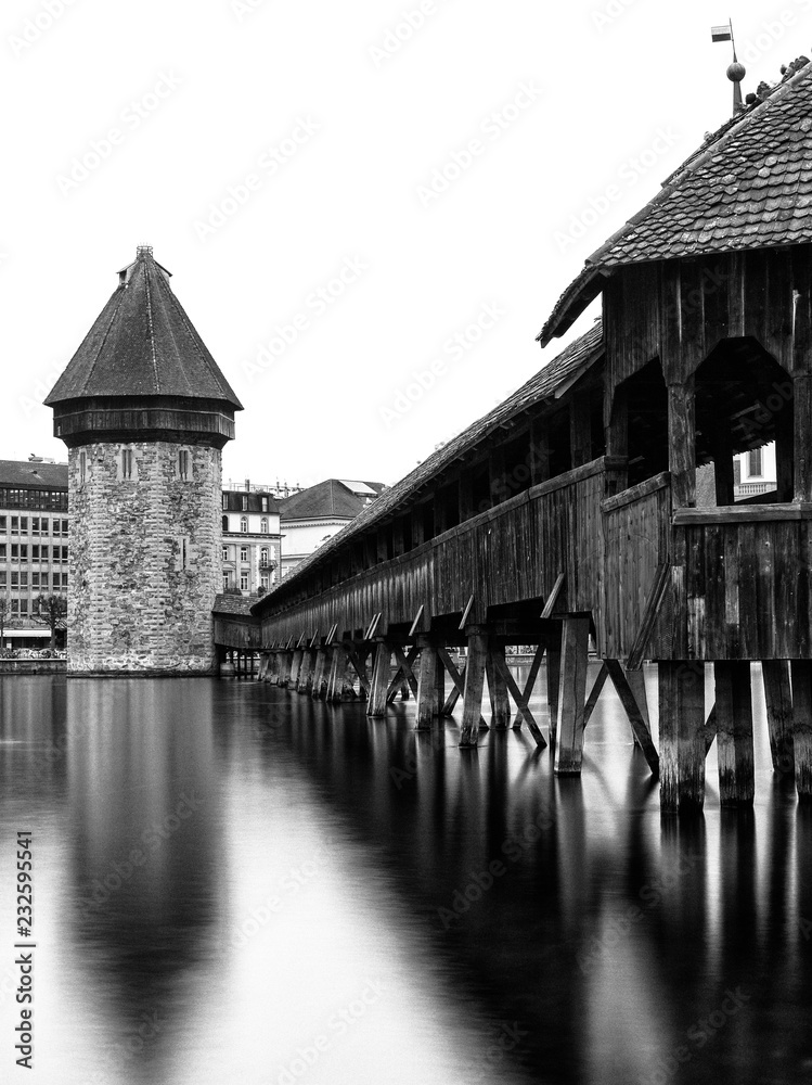 Kappel bridge in Luzern with the water tower vertical view in black and white long exposure