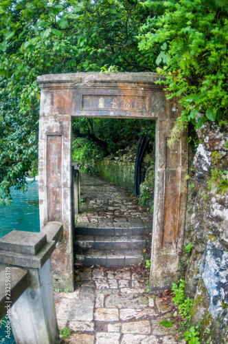 Fototapeta Naklejka Na Ścianę i Meble -  Stone deck of doors near the lake