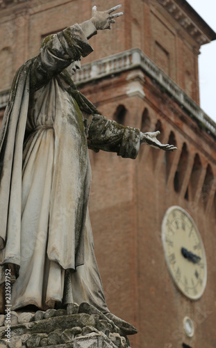 Big statue of Savonarola Girolamo in Ferrara in Italy and the tower