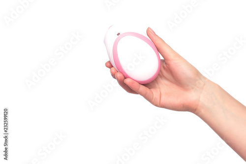 The girl holds in her hand on a white background a fetal doppler to listen to the baby's heartbeat, close-up, isolate, copy space photo
