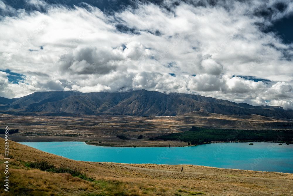 Blue lake and mountains, dramatic cloudy sky, Lake Tekapo, New Zealand
