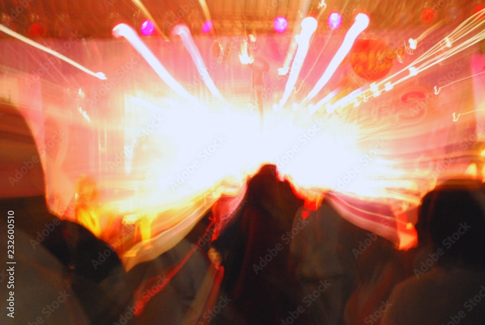 Crowd enjoying concert or party, large group celebrating new year holiday, Abstract motion blurred image for fun concept. Crowd enjoying concert or party, large group celebrating new year holiday, Abstract motion blurred image for fun concept.
