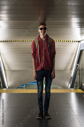 Smiling tall man touching ceiling with head